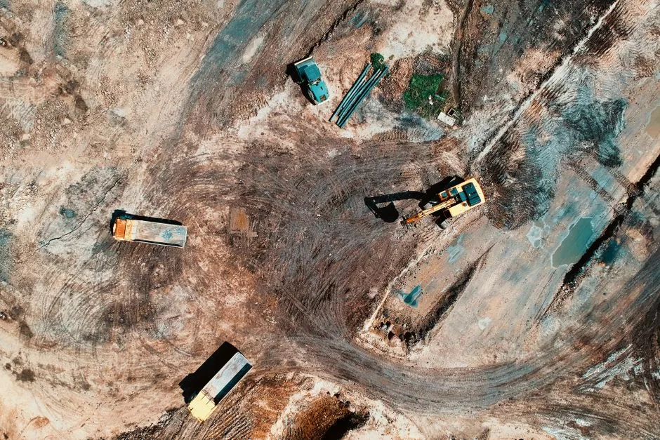 Excavator moving earth on a dirt worksite